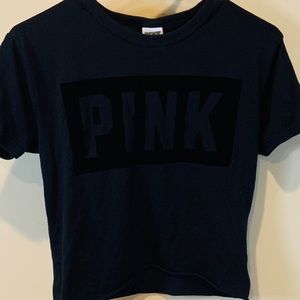 A Black shirt with The word pink on it in velvet